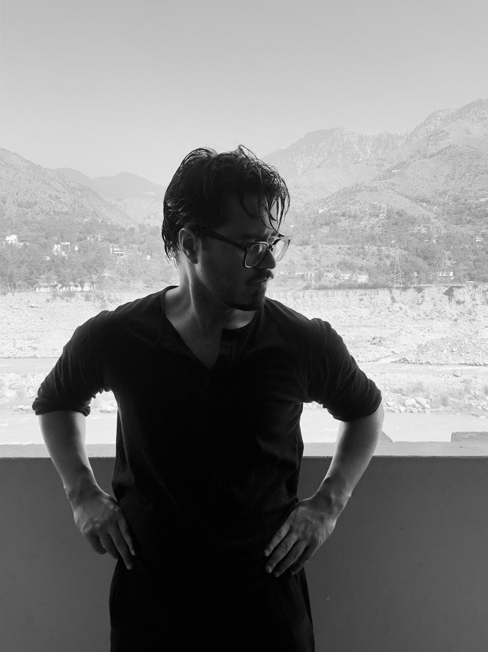 Faaiz Muzzammil on a balcony in Islamabad, the foothills and river valley behind him